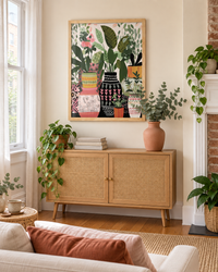 Lifestyle: living room — A narrow, sun-filled Philadelphia rowhouse living room with original brick detailing softened by fresh paint and a calm, plant-friendly interior.