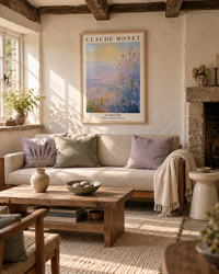 Lifestyle: living room — A 17th-century thatched cottage in rural Dorset — low ceilings, limewashed plaster walls, flagstone floors, and small casement windows that flood morning light across the room.