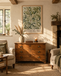 Lifestyle: living room — A mid-terrace Cotswolds limestone cottage in Chipping Campden — low beams, limewash plaster, casement windows overlooking a cottage garden.