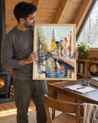 Lifestyle: home office / study — A compact Catskills A-frame used as a full-time creative retreat — steep wood-clad interior walls, a sleeping loft above, a simple writing desk beneath the triangular side window, exposed Douglas fir rafters and a wood-burning stove in the corner.