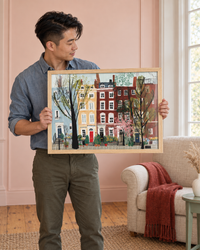 Lifestyle: living room — 1840s Upstate New York Greek Revival house in Hudson — wide-plank pine floors, panelled walls, dentil cornice, owned by a couple in their late 30s who treat the home as a long-term restoration project; grandmillennial-English-country aesthetic with chintz and antiques