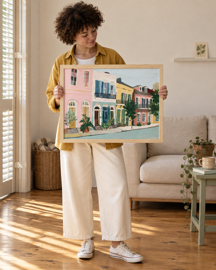 Lifestyle: living room — A Charleston single house in the lower peninsula — one room wide, tall shuttered windows, heart pine floors, a gracious side piazza, the whole place quietly elegant despite its compact plan