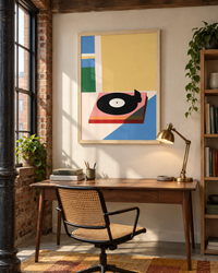 Lifestyle: home office / study — A converted warehouse flat in Ancoats, Manchester — exposed brick sections, cast-iron columns, tall steel-framed windows, original heavy timber beams, polished concrete floor areas.