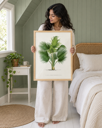 Lifestyle: bedroom — New England Cape Cod cottage in coastal Massachusetts — beadboard-panelled bedroom, low eaves, dormer window, painted in calm dusty sage green, with a rattan headboard and linen bedding.