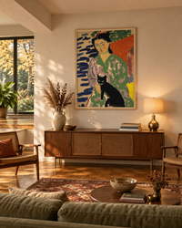 Lifestyle: living room — A 1970s split-level outside Columbus, Ohio — sunken living room with original wood-panelled accent wall painted out in chalky off-white, low wide picture windows, parquet floor, high ceilings on the upper half
