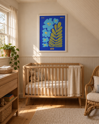 Lifestyle: nursery — A 1940s Cape Cod cottage in coastal Massachusetts — beadboard ceilings, wide-plank painted floors, small double-hung windows with sheer linen curtains, and a nursery carved out of the upper half-storey with sloped ceilings and warm lamplight.